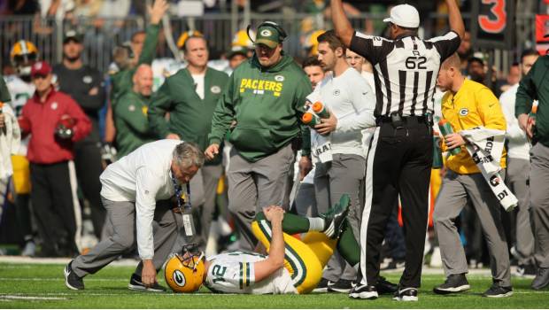 Aaron Rodgers se duele sobre el césped.